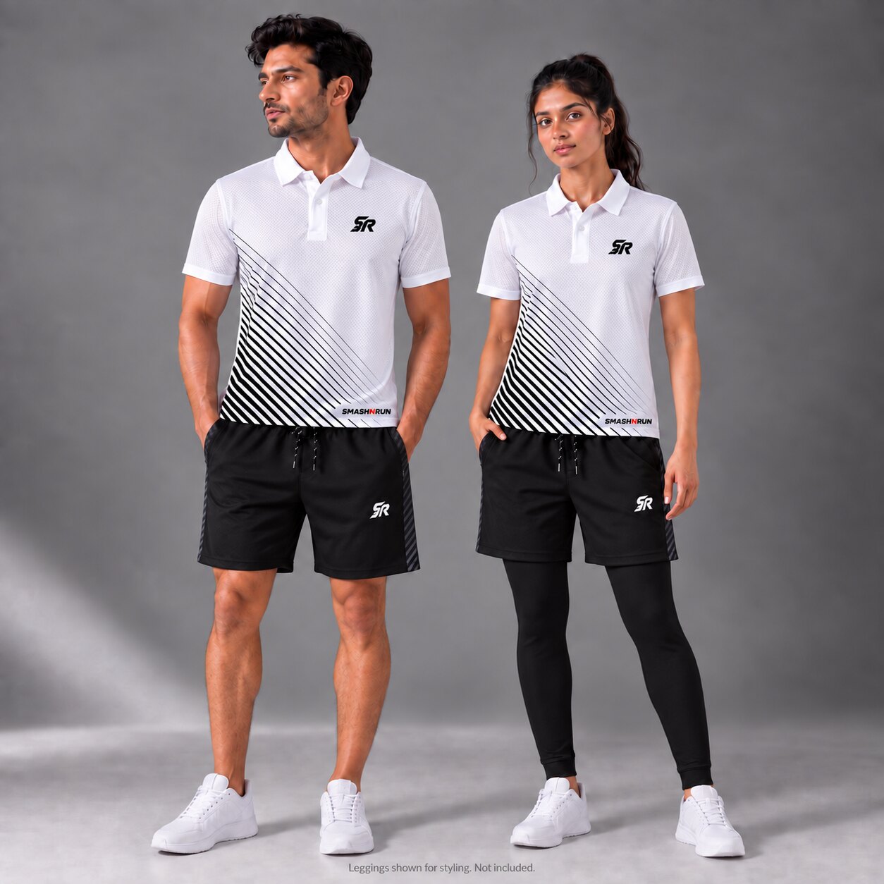 Man and woman wearing the Aura Polo in white with Aura Shorts in black