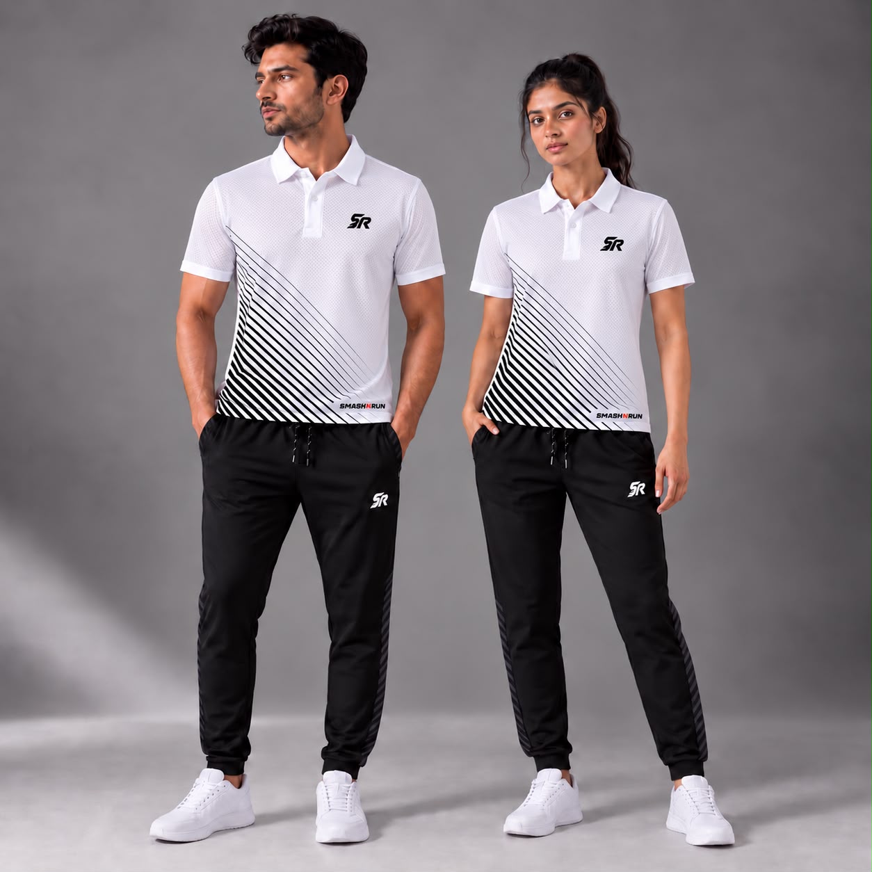 Man and woman wearing the Aura Polo in white with Aura Track Pants in black