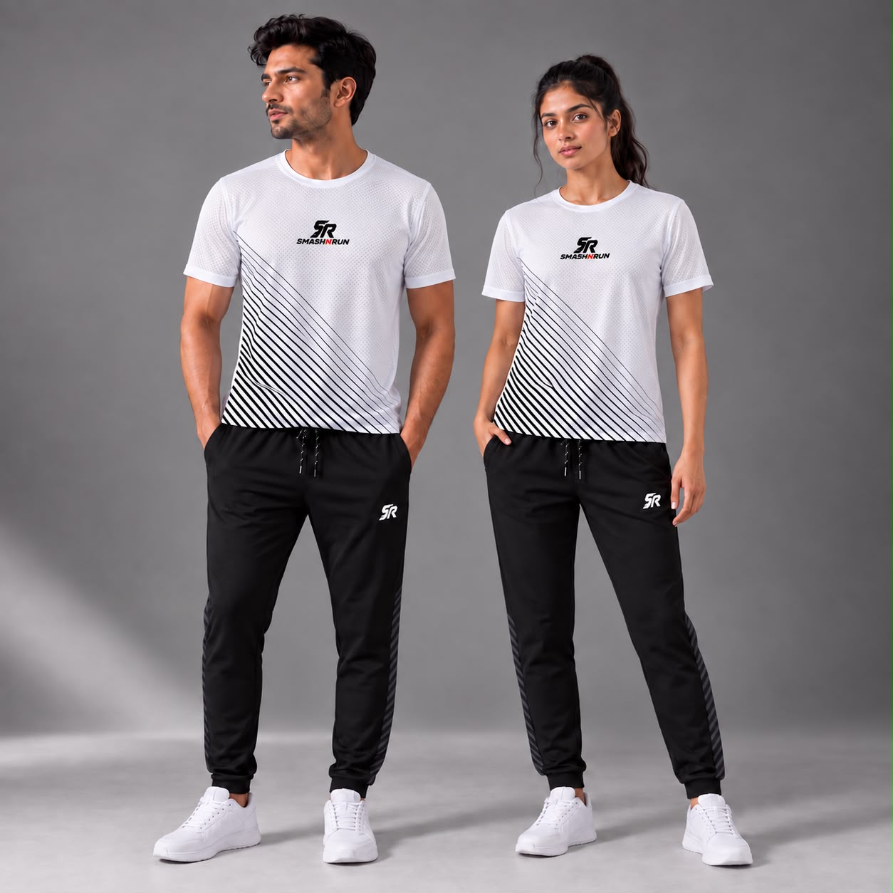 Man and woman wearing the Aura Tee in white with Aura Track Pants in black